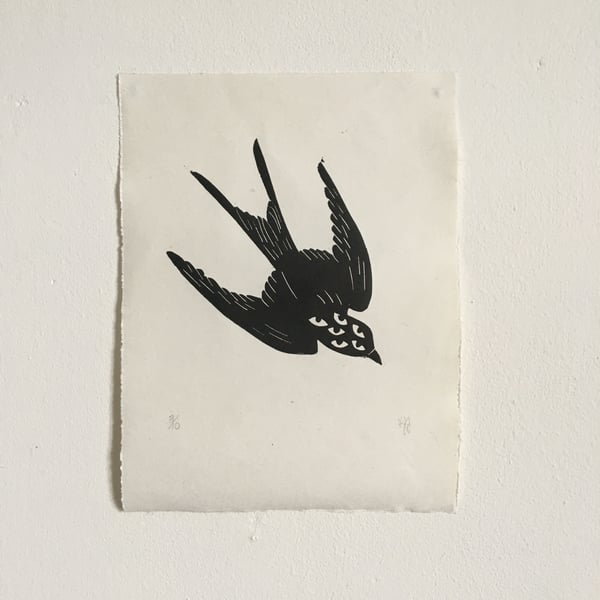 Migration, linocut print of a swallow