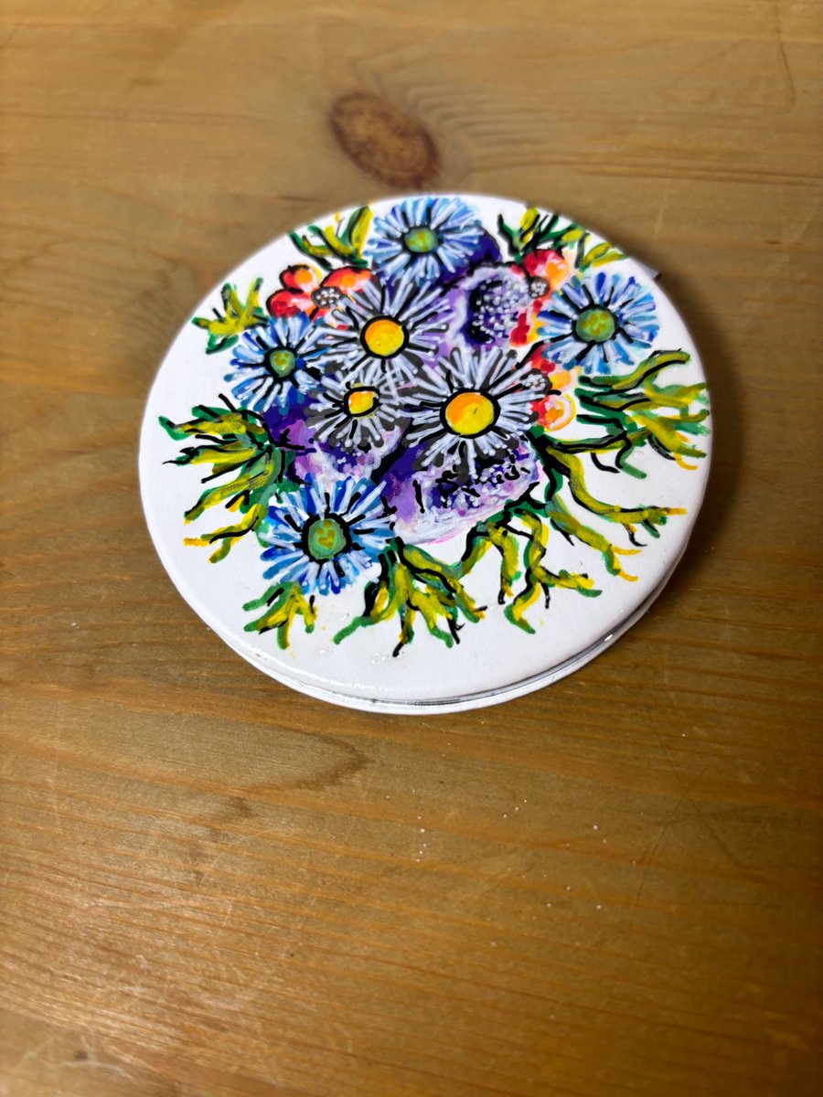 A hand painted and sealed compact mirror by Andrew Jenkins
