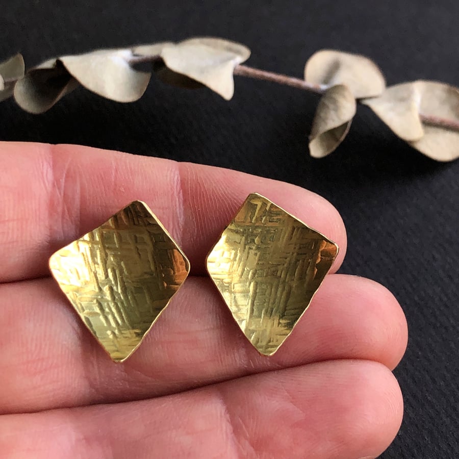 Brass and sterling silver stud earring.