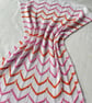 Orange, pink, and white striped baby blanket in cotton mix yarn  - Image 1