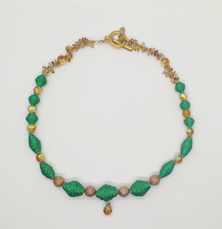 An unusual necklace  made of glittery green paper beads