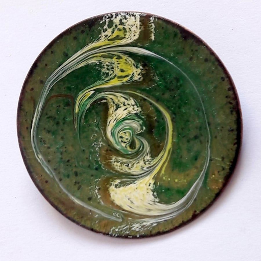 brooch - round: scrolled white, gold and brown over green on clear enamel