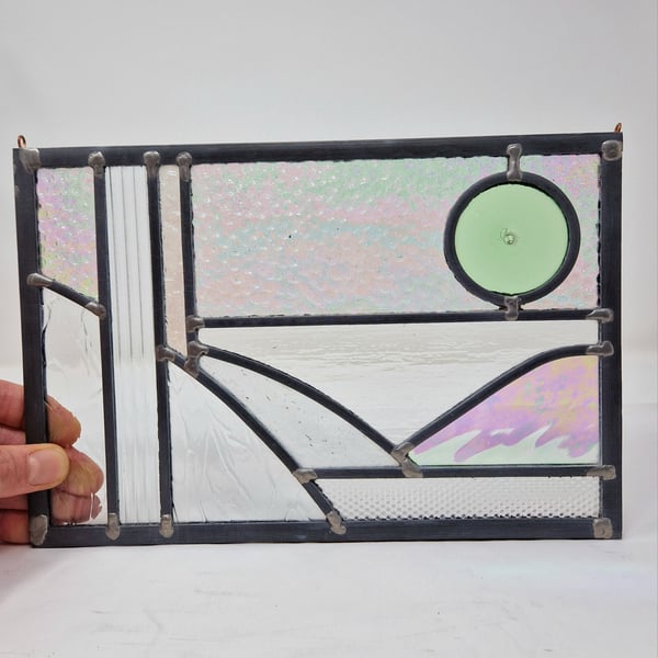 Stylised stained glass landscape transparent textured leaded panel.