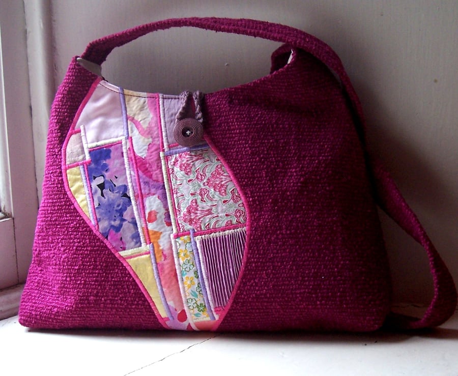 Soft fabric shoulder bag in magenta and pink with patchwork feature