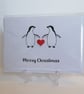 Merry Christmas card with two penguins and a red heart button