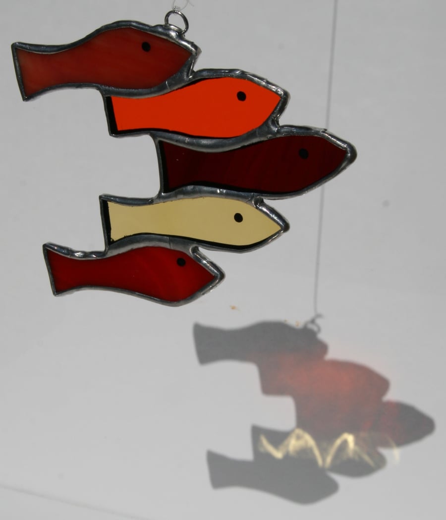 Handmade reds shoal of fish using various types of stained glass suncatcher.