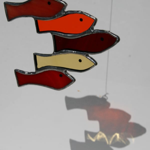 Handmade reds shoal of fish using various types of stained glass suncatcher.