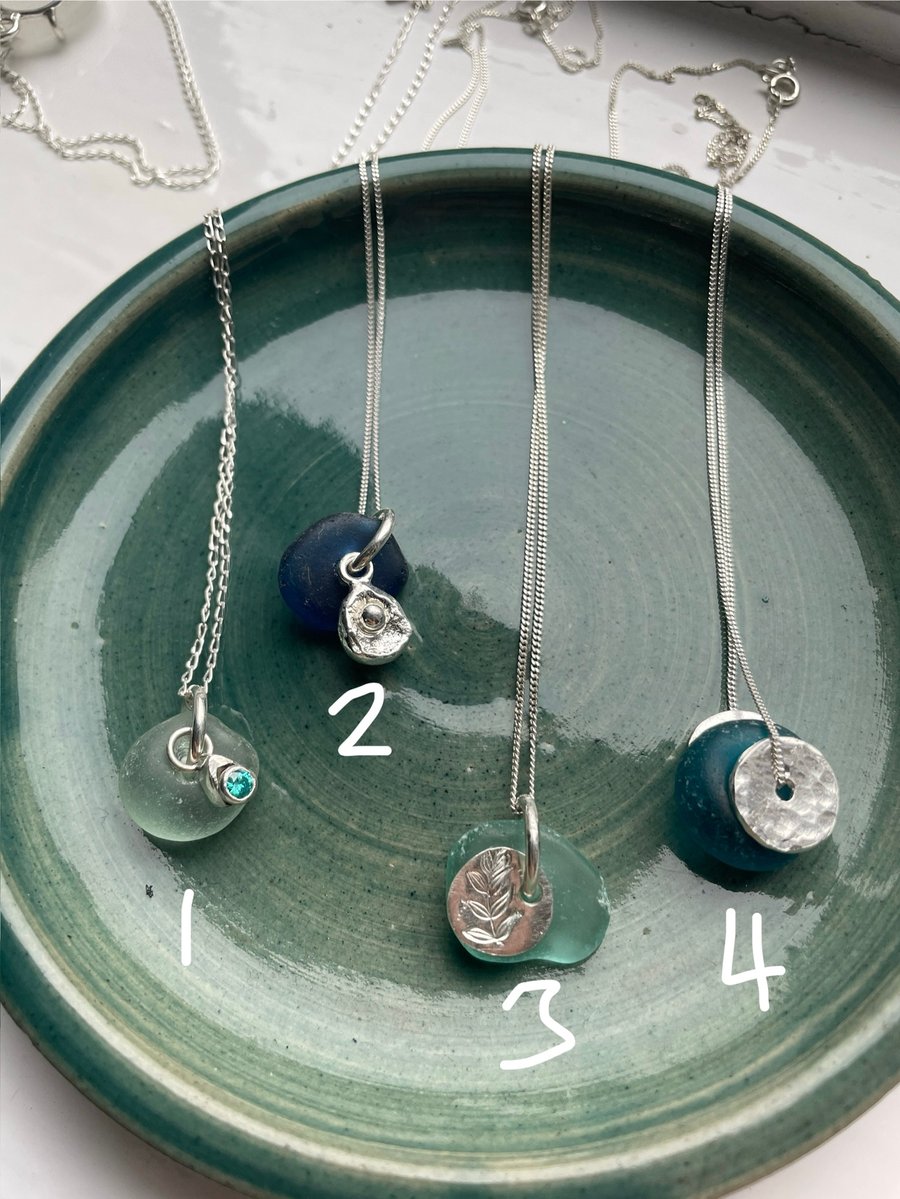 Small, blue sea glass pendant with silver accent