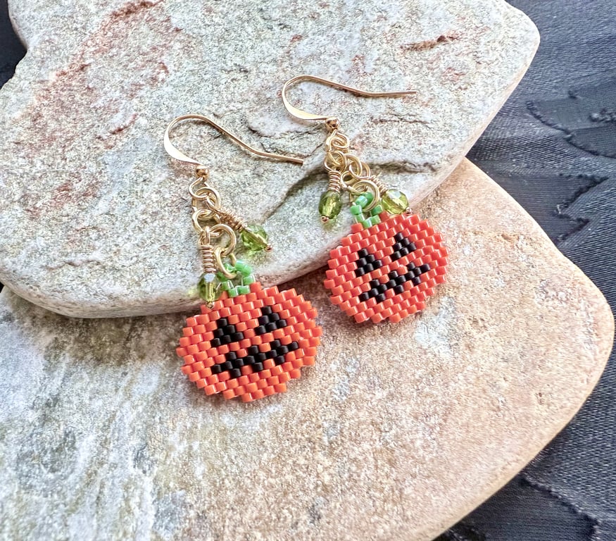 Orange Halloween pumpkin earrings with peridot green Czech glass drops