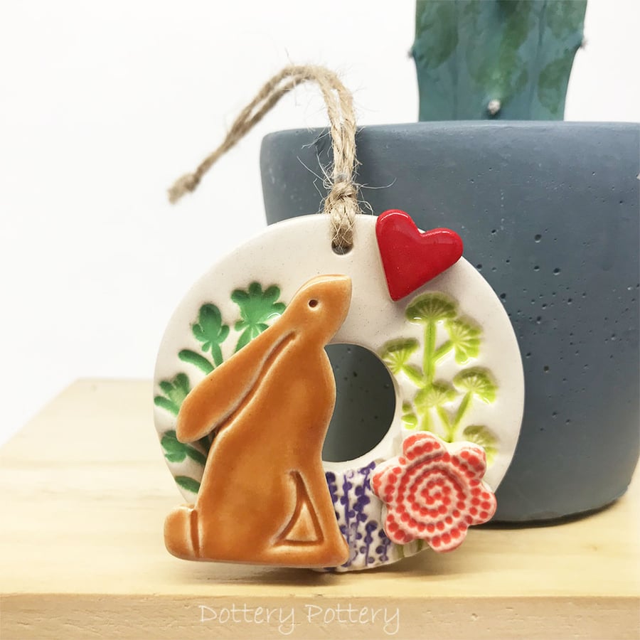 Small ceramic hare decoration with summer flowers red