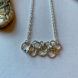 Ring and granule pendant on trace chain. Length 16"