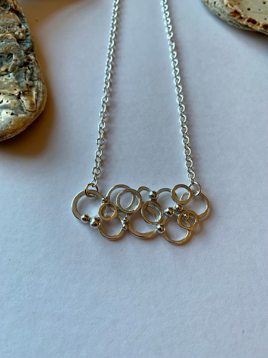 Ring and granule pendant on trace chain. Length 16"