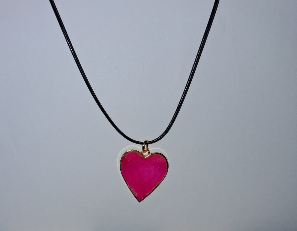 Handmade resin pink shimmer heart pendant on  black waxed cord