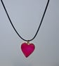 Handmade resin pink shimmer heart pendant on  black waxed cord