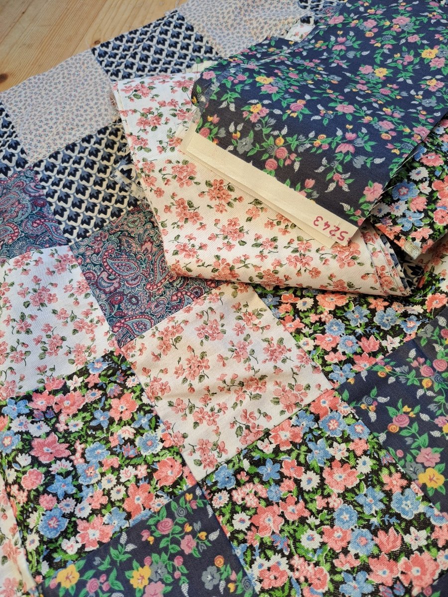 Unfinished quilt top with lots of fabric