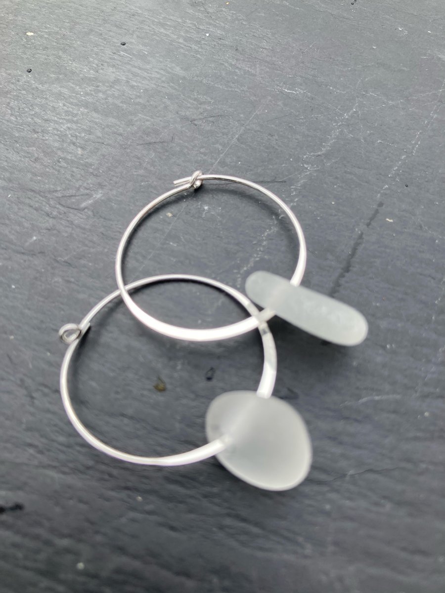 Sterling silver hoop earrings with white seaglass drops.