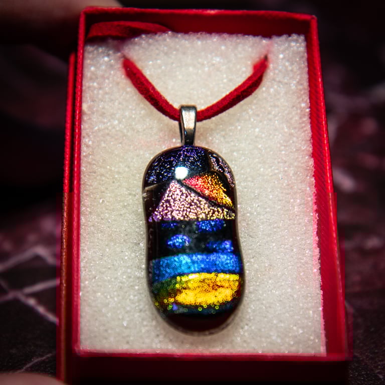 Hand made dichroic fused glass pendant on suede cord in red presentation box