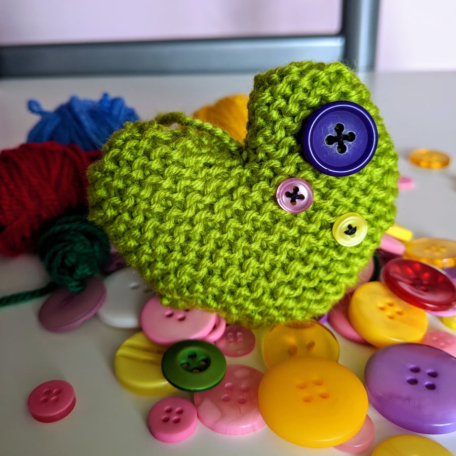 Hand-knitted bright green button heart