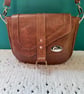 Brown crossbody saddle bag in soft faux leather