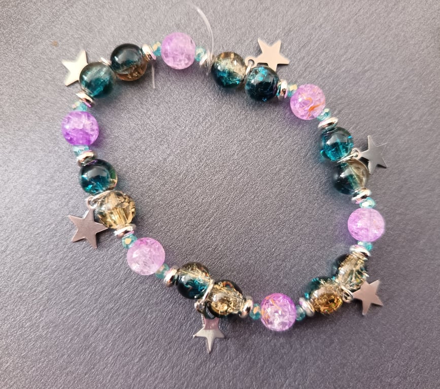 Elasticated blue and purple beaded bracelet with star charms 