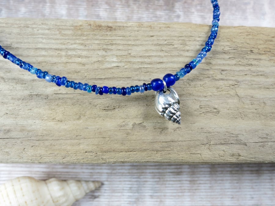 Seed Bead Necklace with a Silver Coated Little Bear Conch Shell - Blue Beads