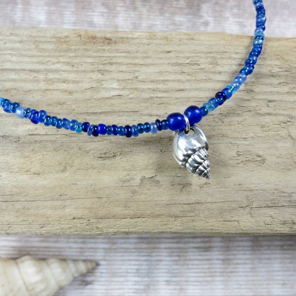Seed Bead Necklace with a Silver Coated Little Bear Conch Shell - Blue Beads