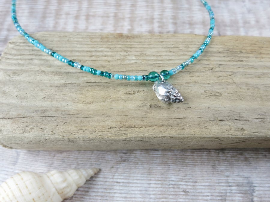 Seed Bead Necklace with a Silver Coated Little Bear Conch Shell - Turquoise