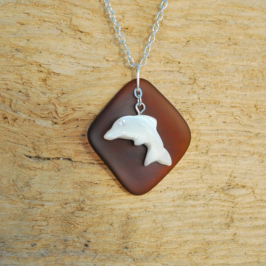 Brown beach glass pendant with dolphin charm