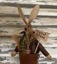 A gorgeous primitive bunny in a rusty tin bucket