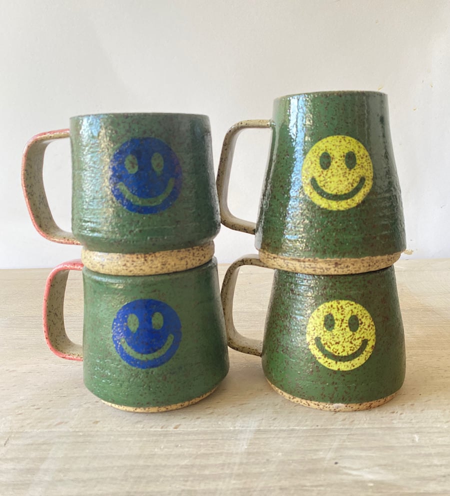 Set of 4 speckled smiley cups.