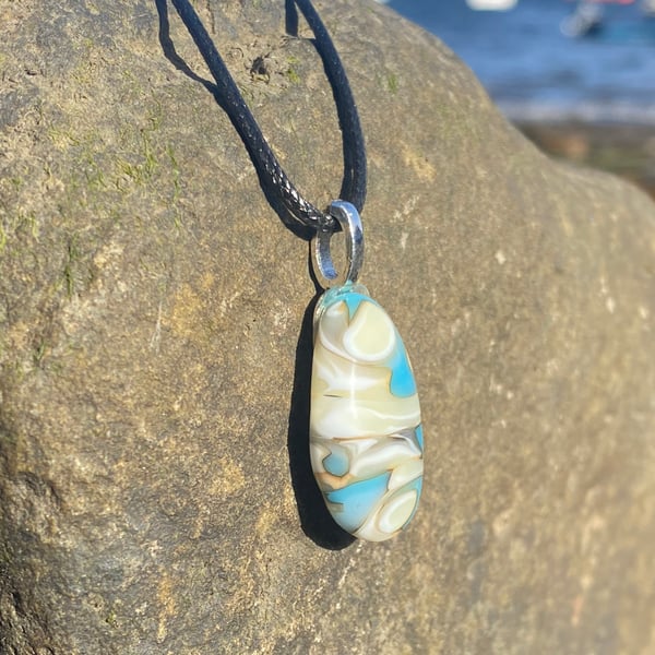 Cream and pale blue swirl puddle fused glass pendant