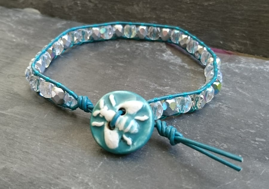 Teal leather and AB coated faceted glass bead bracelet with ceramic bee button