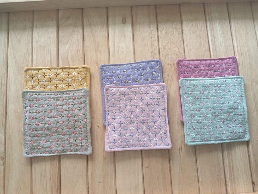 Set of six handmade coasters with sashiko embroidered patterns.