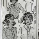 A vintage sewing pattern for a woman's blouse in 3 styles and size 18 