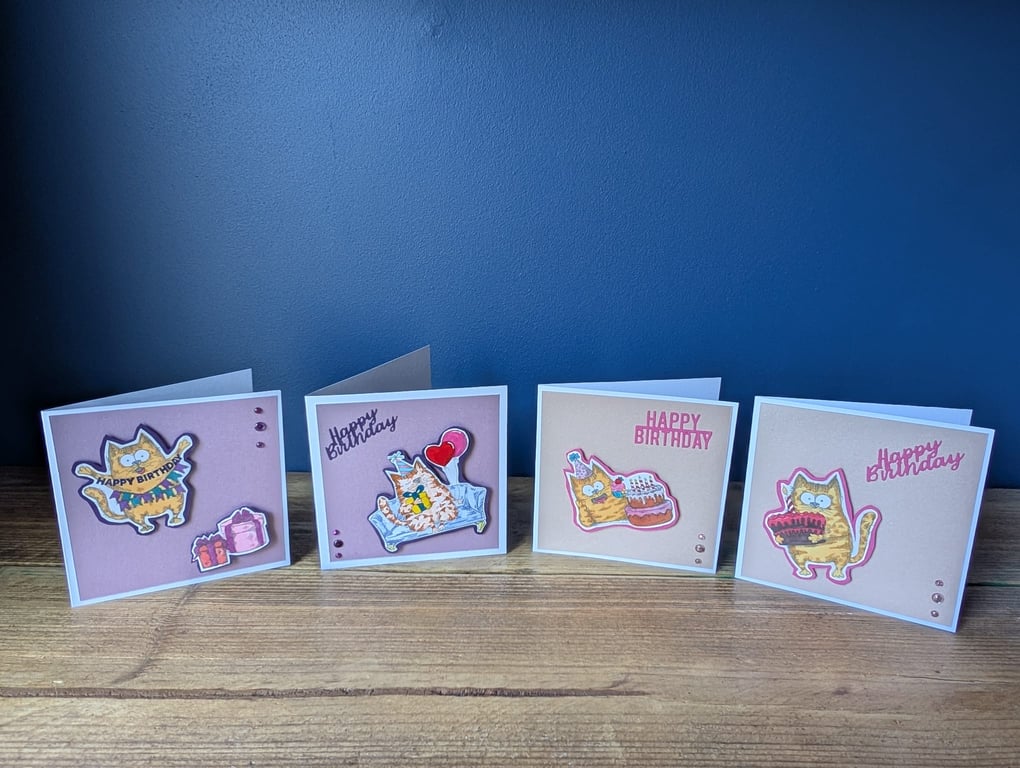 Four handmade birthday cards with hand-coloured cat stamps with envelopes