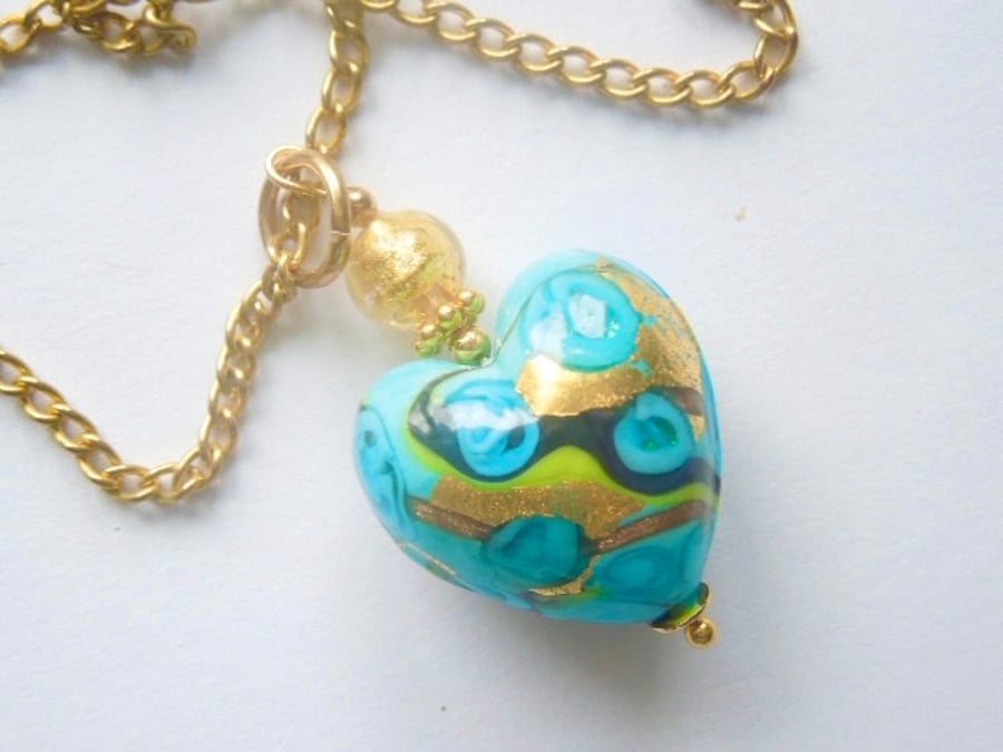Murano glass pendant with aquamarine blue and gold Murano bead and gold chain.