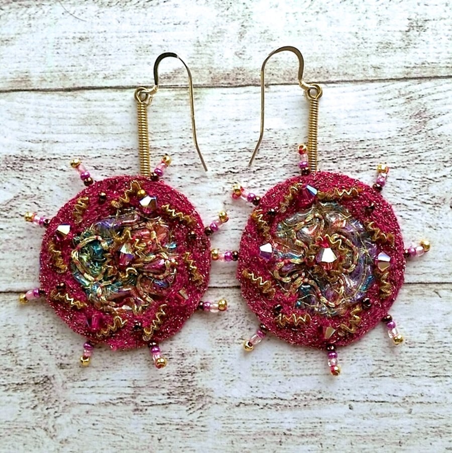 Textile embroidery and beaded earrings.