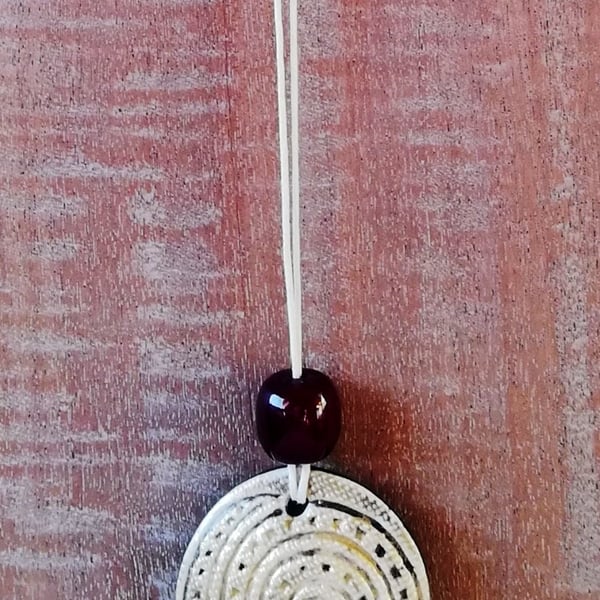 Stoneware necklace: a round ceramic white glaze spiral with Victorian amber bead