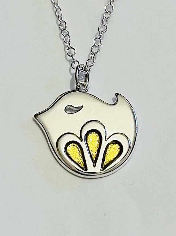 Sterling silver bird pendant with flower motif and gold enamel detail