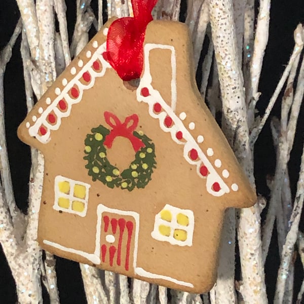 Gingerbread style hanging house decoration with hand painted design