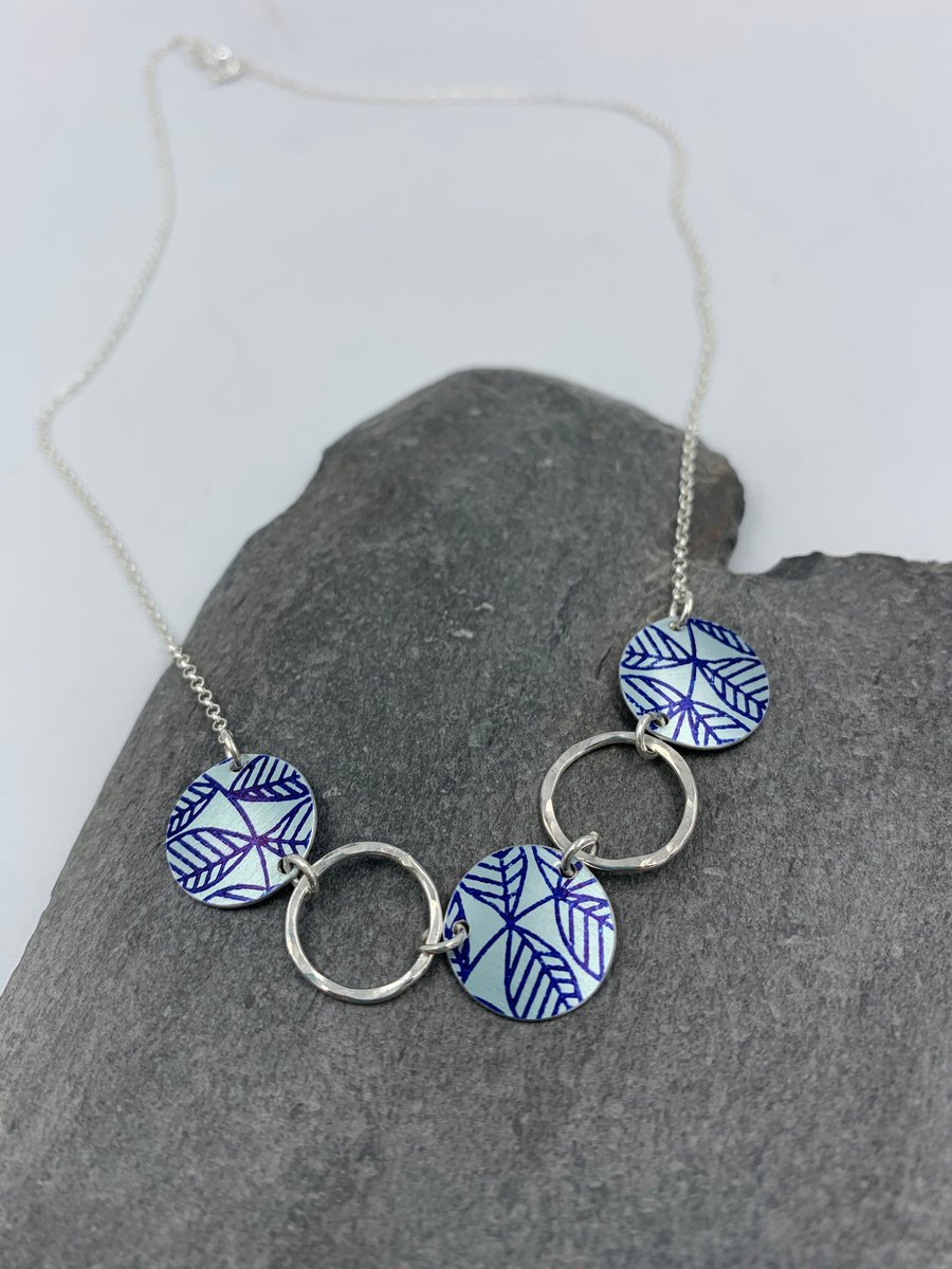 Silver and navy circle leaf necklace with recycled silver rings