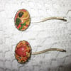 Pair of 'cherub' glass cabochon hair grips