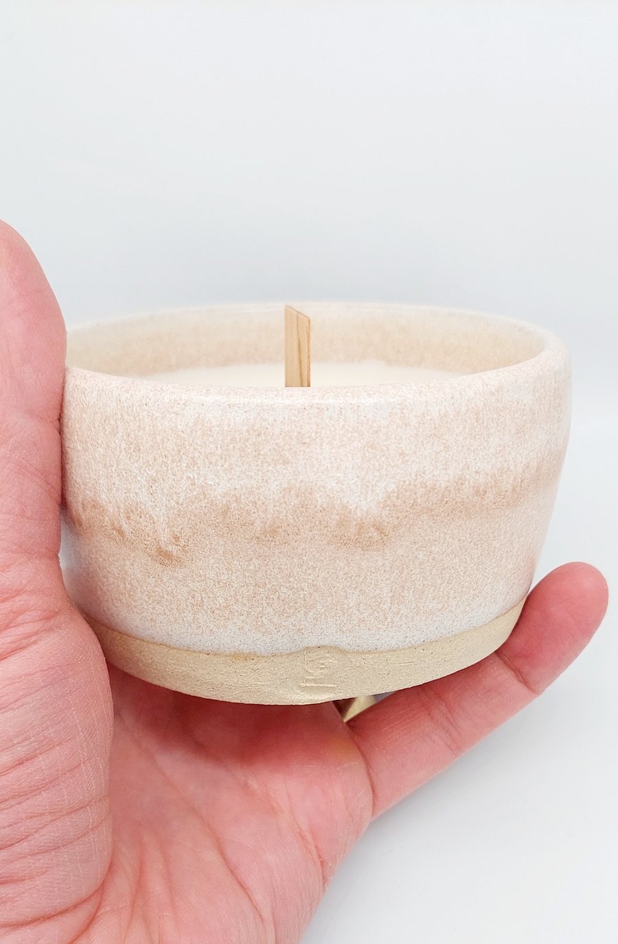 Scented soy candle in handmade ceramic holder