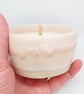 Scented soy candle in handmade ceramic holder