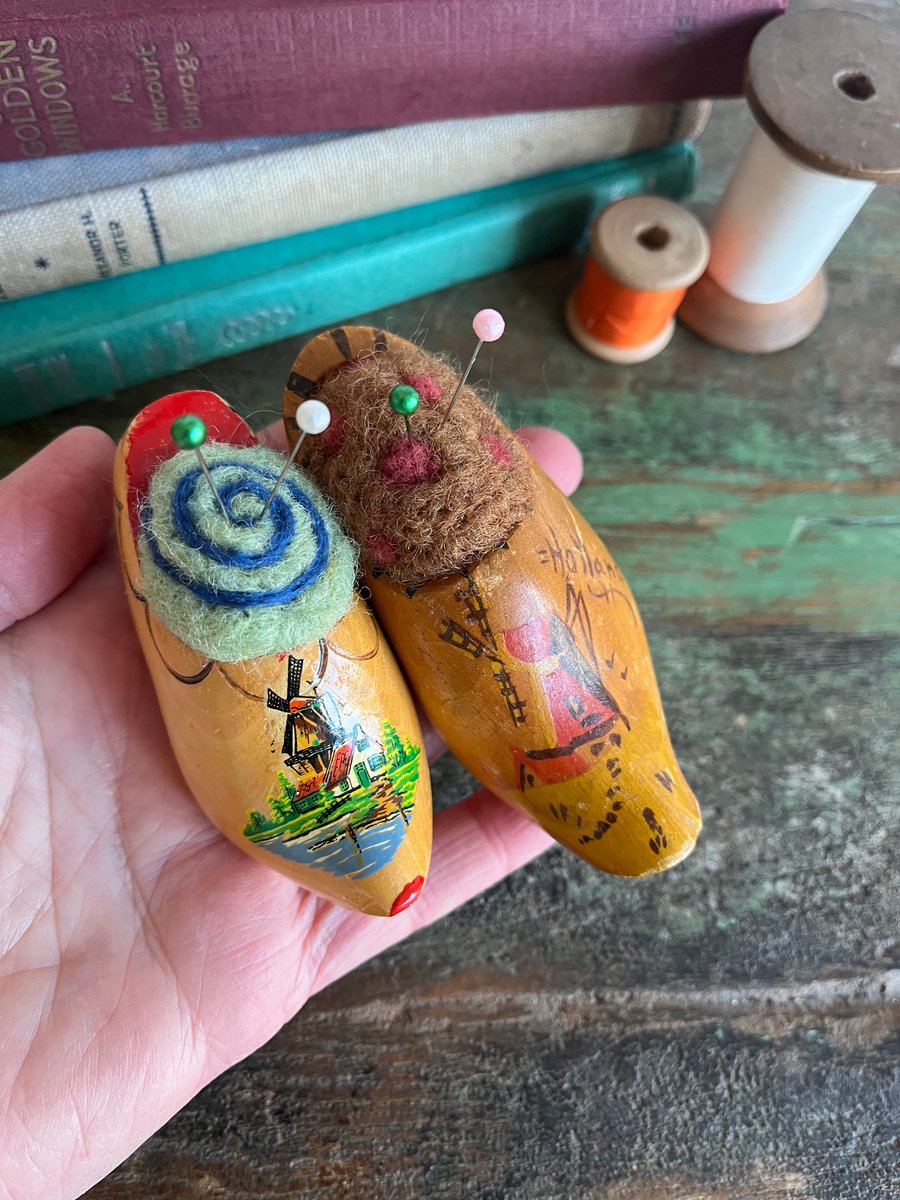 Pair of pincushions in wooden souvenir clogs with needle felted cushions