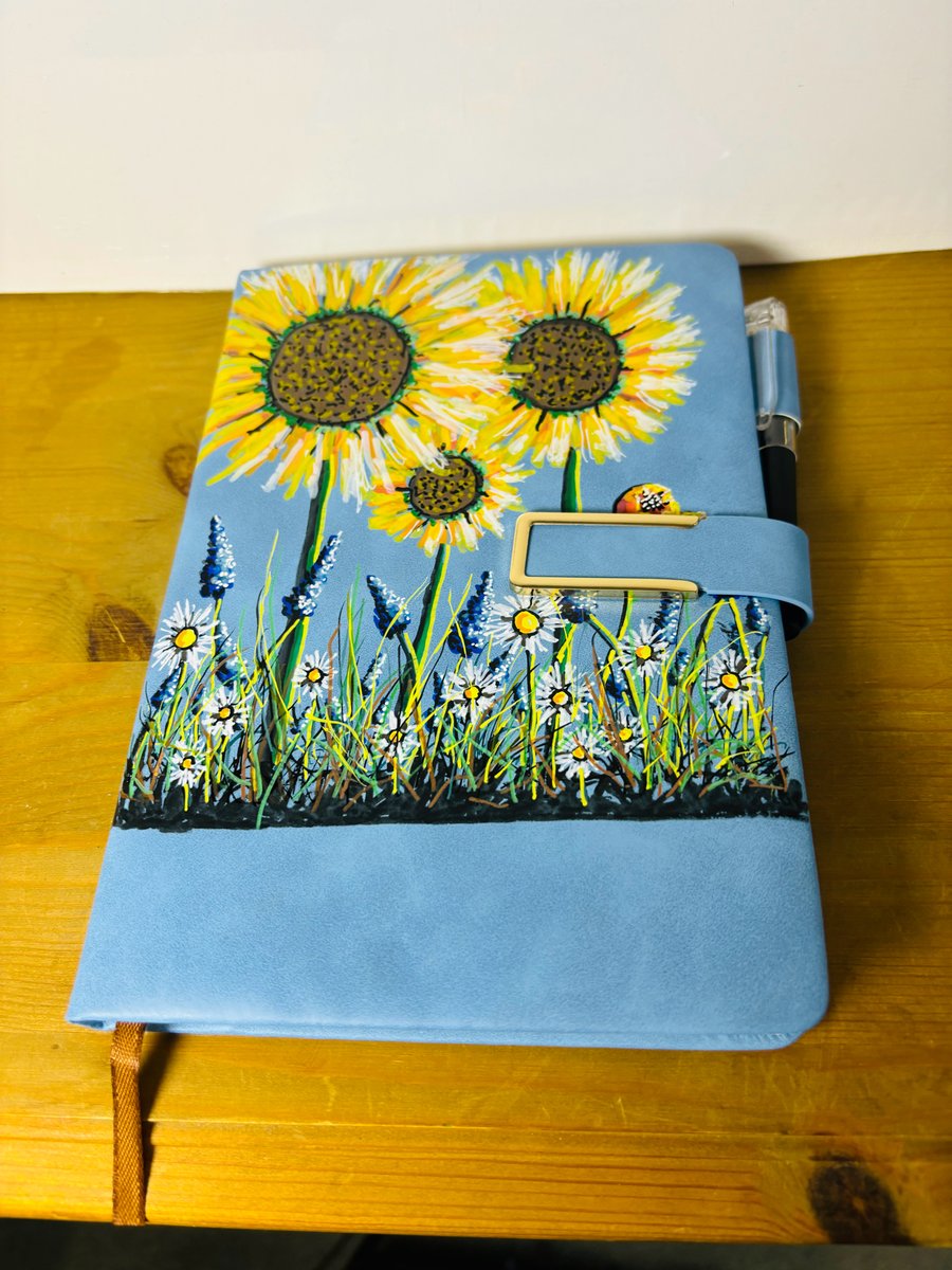 A hand painted faux leather covered notebook by Andrew Jenkins 