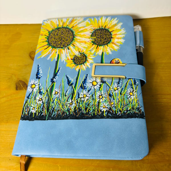 A hand painted faux leather covered notebook by Andrew Jenkins 