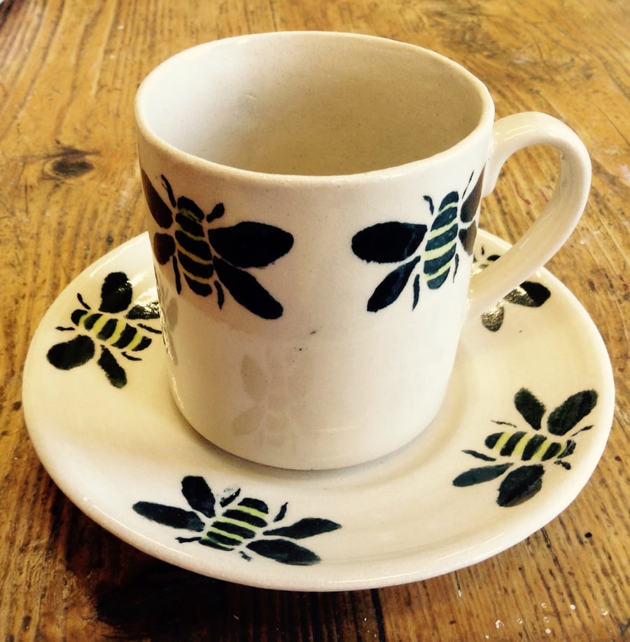 Mug and saucer with bee design in black                 