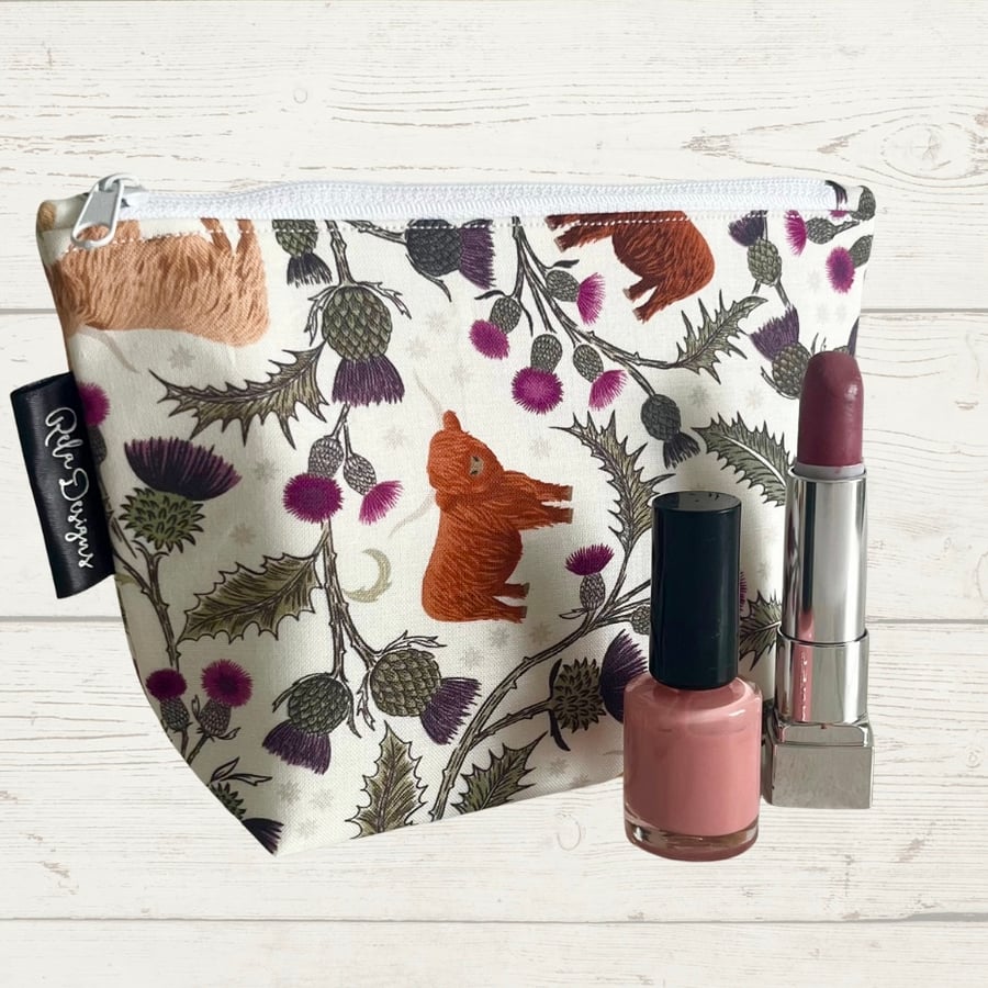 Cosmetic bags highland cows and thistles