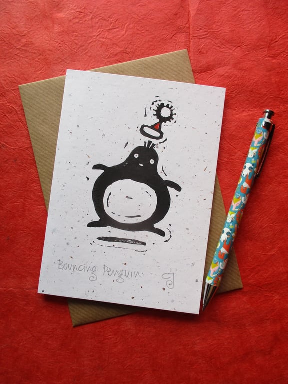 Bouncing Penguin - lino cut print Christmas card